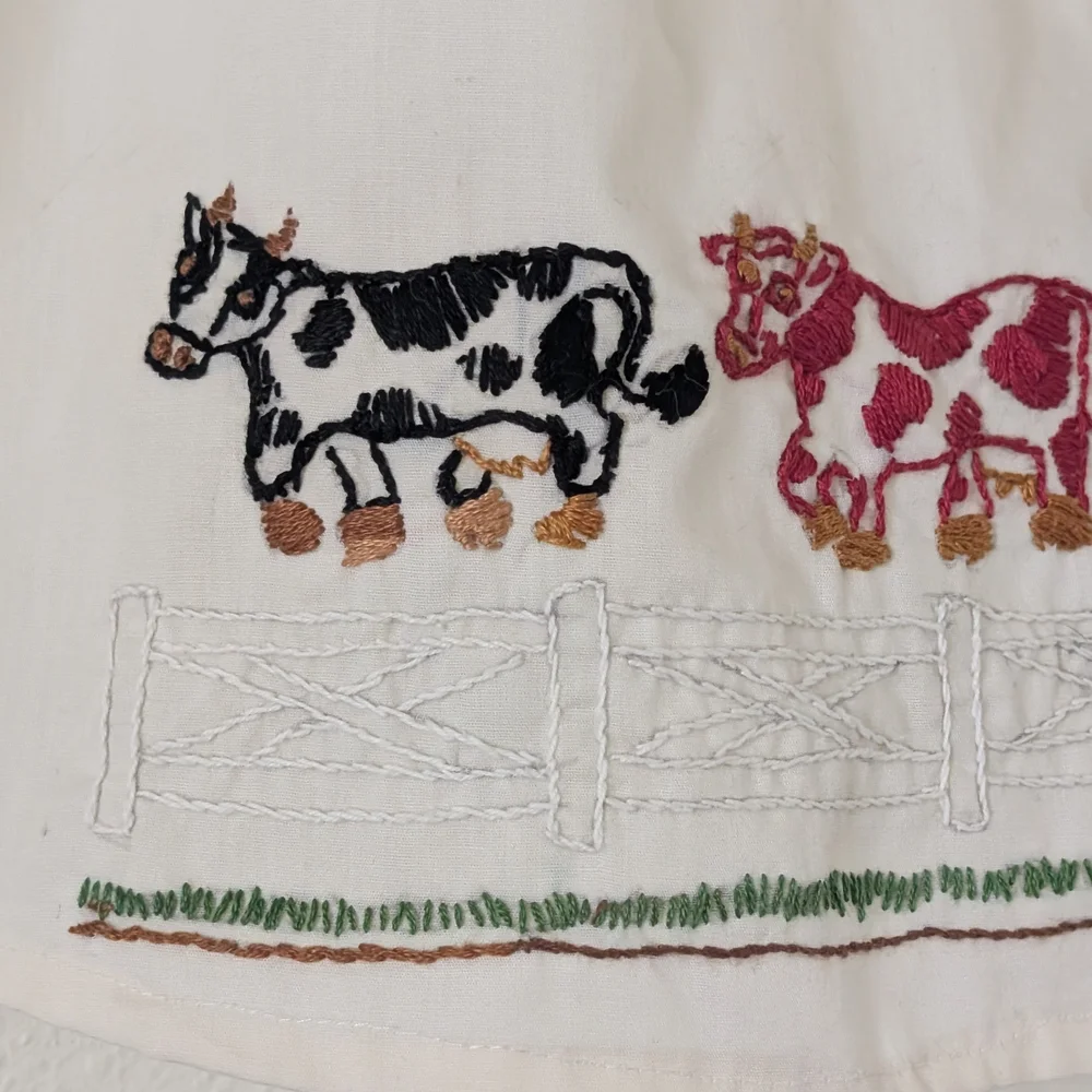 Vintage Hand Embroidered Child's Apron, Cream with Black and Red Cows